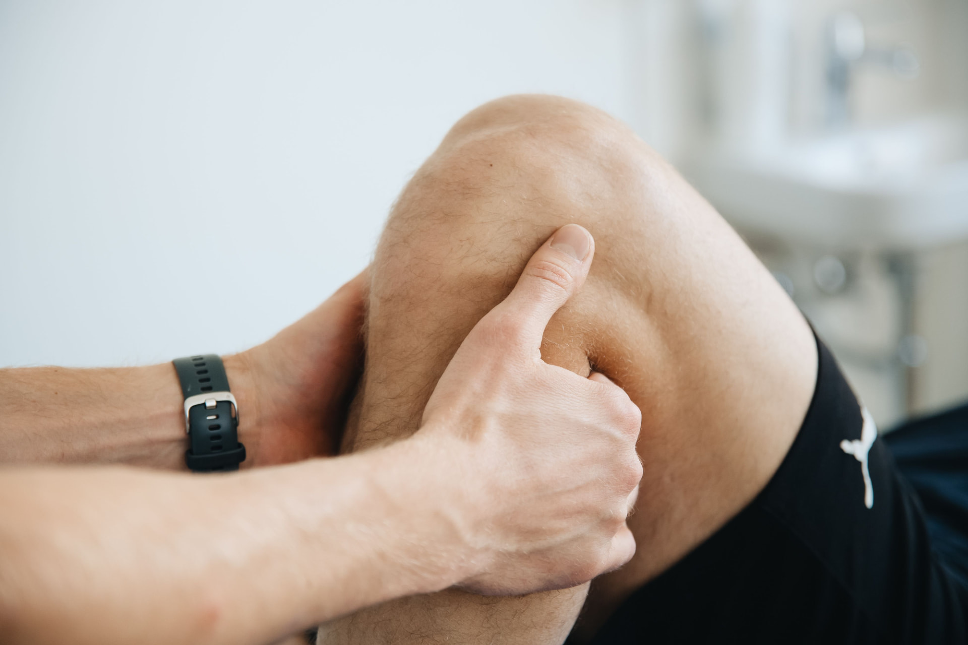 Close-up of joint mobilization and knee palpation during a hands-on alignment session