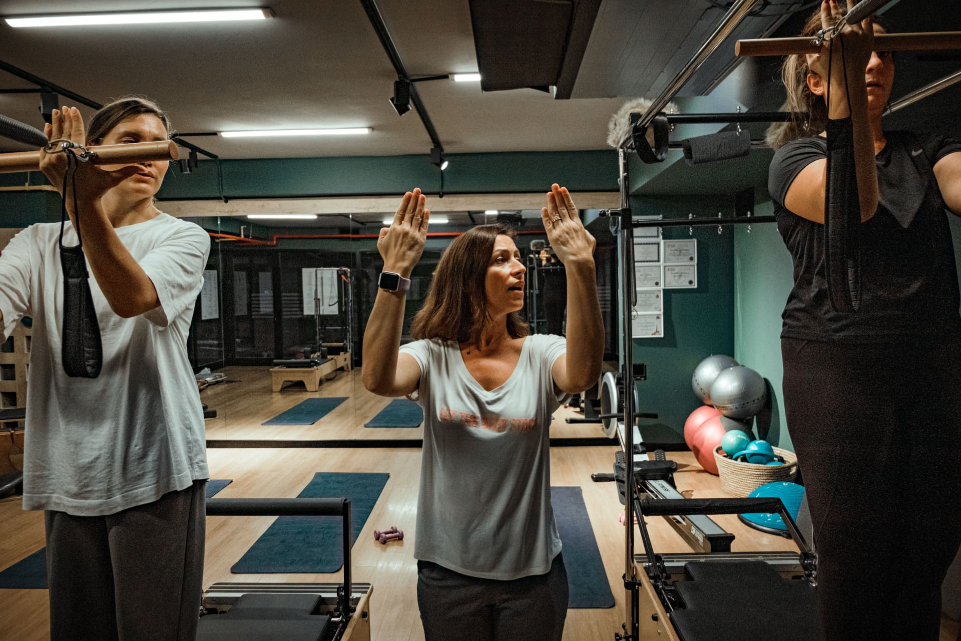 Group Pilates reformer session with instructor guiding participants at the Mountain Rejuvenation Center studio